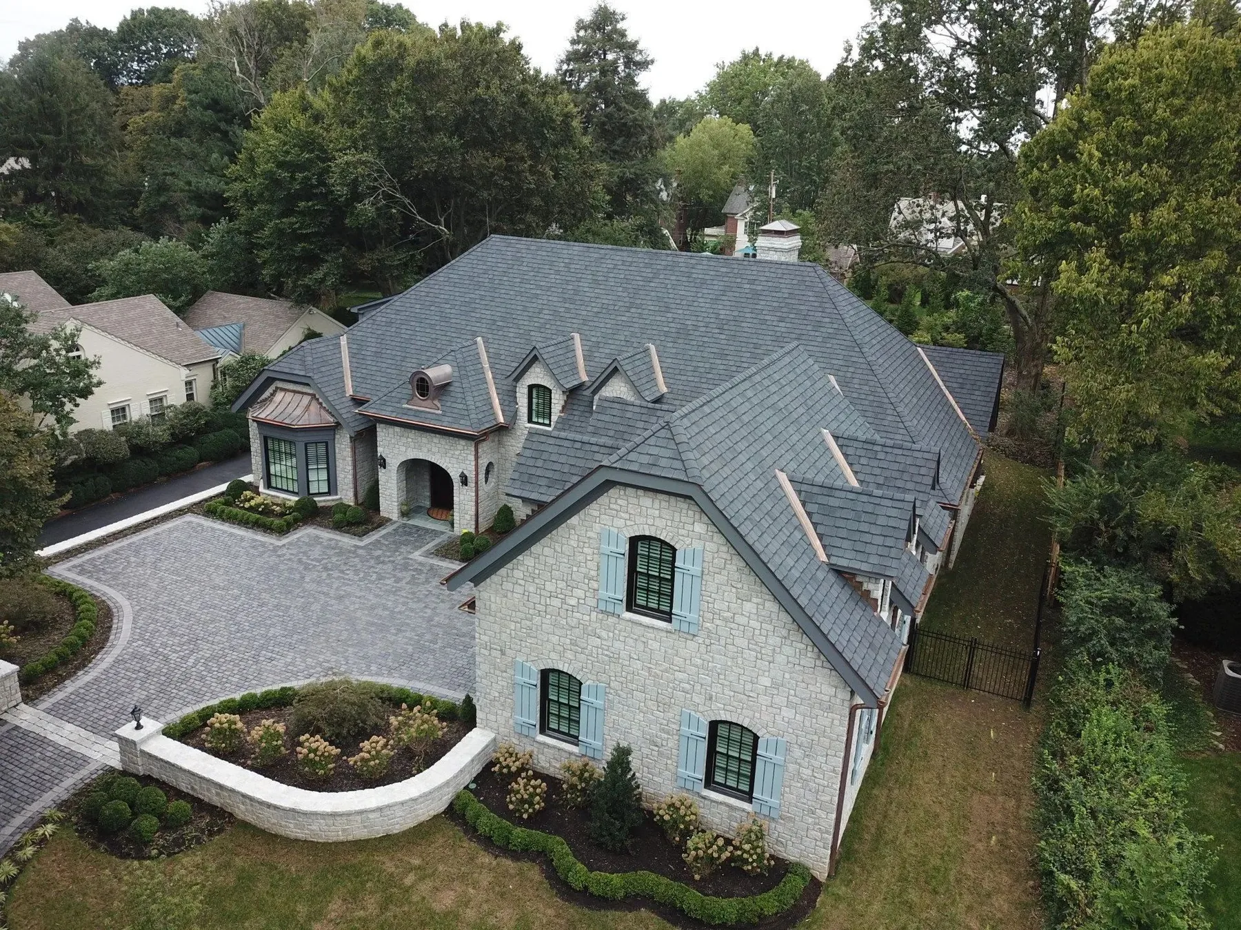Large residential home with a newly installed roof by Isaacs Roofing